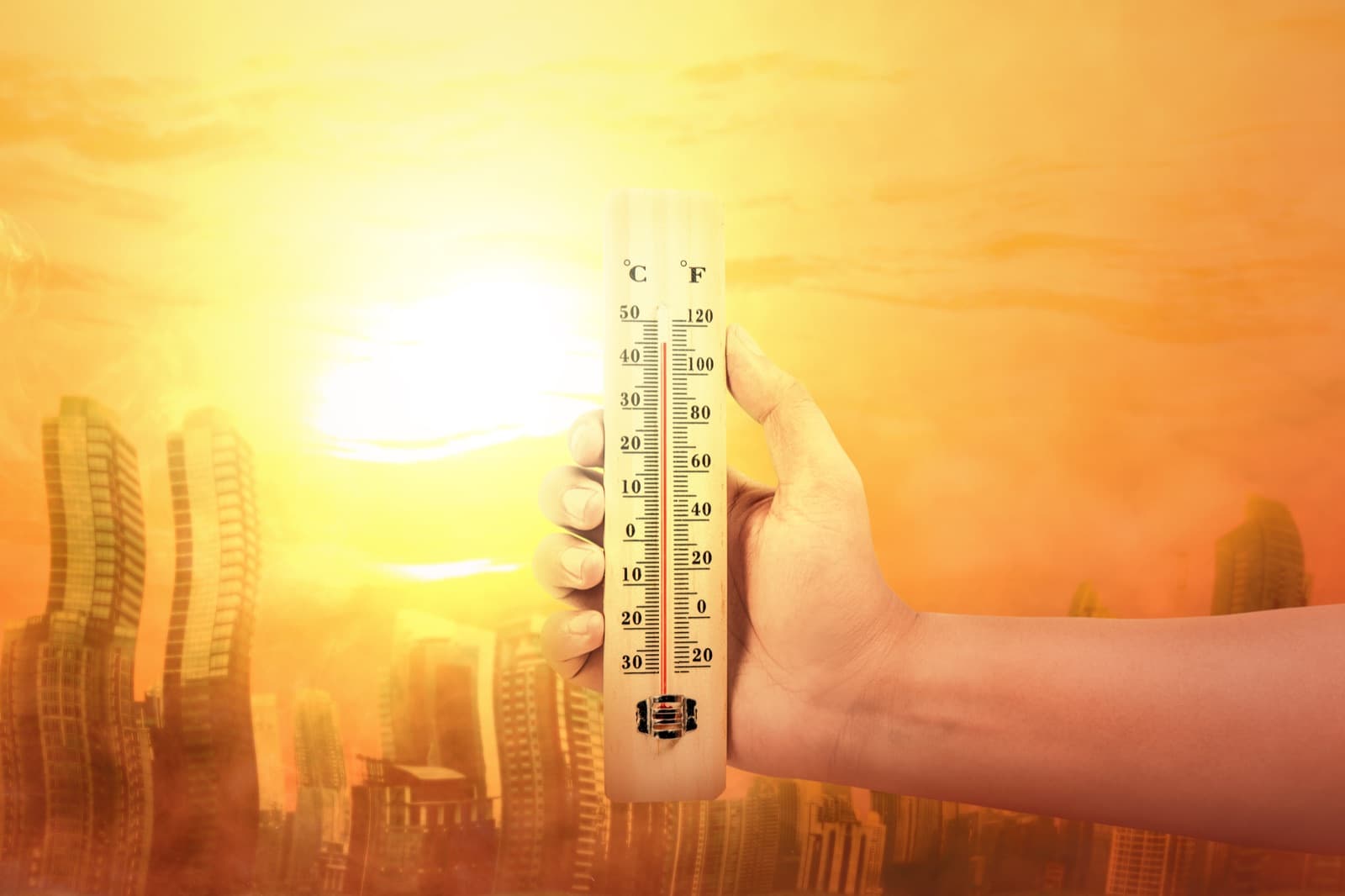 Thermometer reading extreme heat against the sun over a Texas city skyline